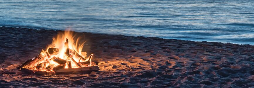 a small fire on a beach