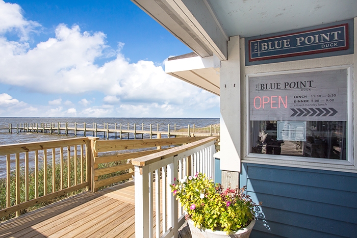 The Blue Point Restaurant | Duck, NC - A building with a wooden fence - Outer Banks